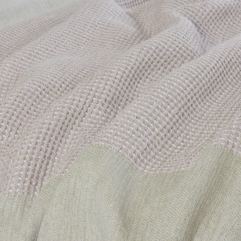 A Pink Woven Blanket on a Bed