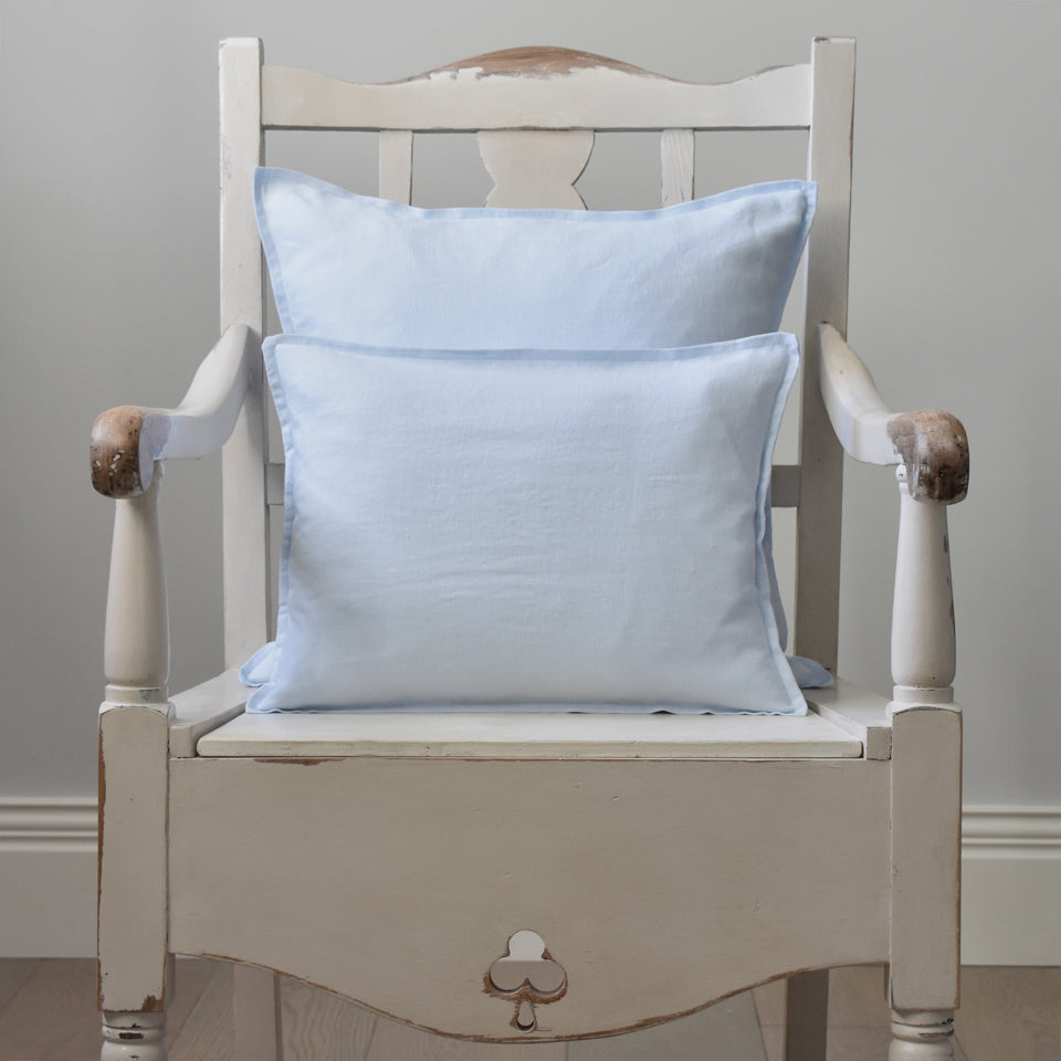 Light Blue Linen Cushion Cover on a Cream Wooden Chair