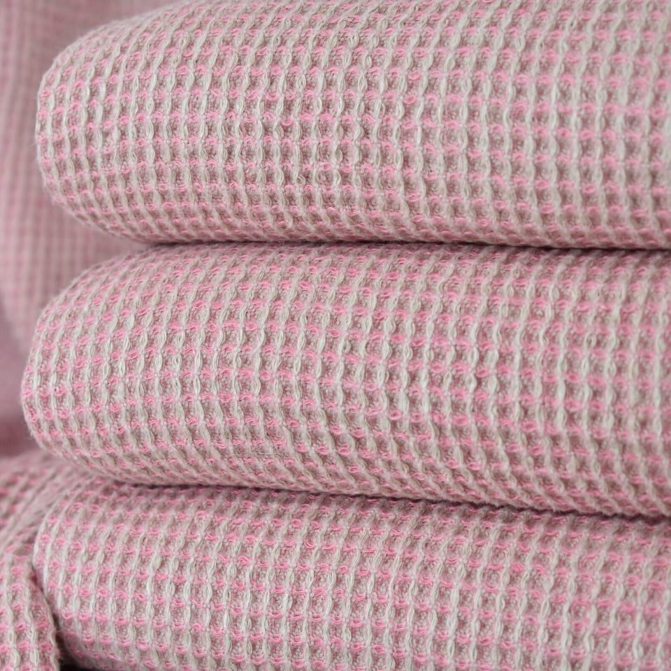 Pink Linen Throws Folded on a chair