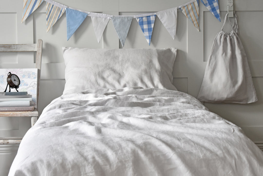 Soft Grey Linen Kids Single Duvet Set on a Bed with Bunting 