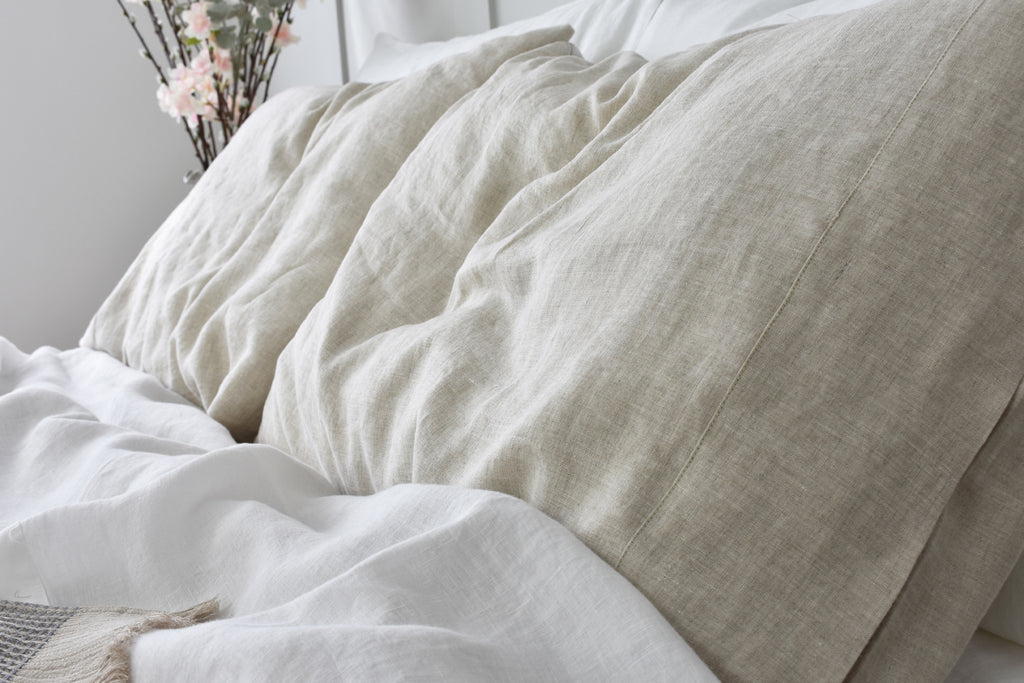 Natural Linen Pillowcase on a Bed with White Sheets