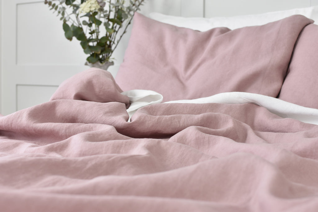 Rose Pink Linen Duvet Cover and White Sheet on a bed with flowers