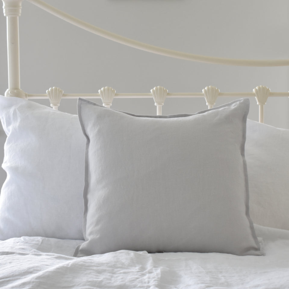 Light Grey Linen Cushion Cover on a White Iron Bed