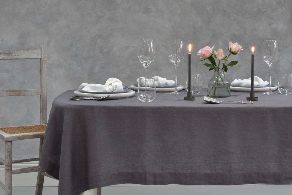 A Grey Linen Tablecloth on a Table with Grey Candles and White Linen Napkins
