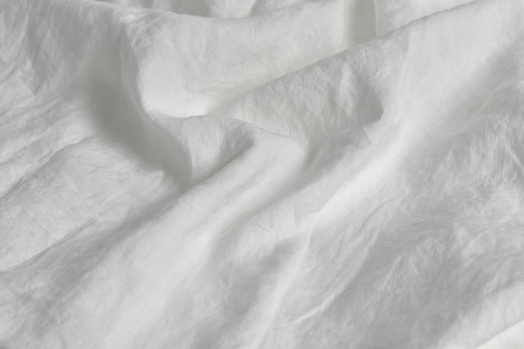 Pure White Linen Sheet on a Bed in the UK