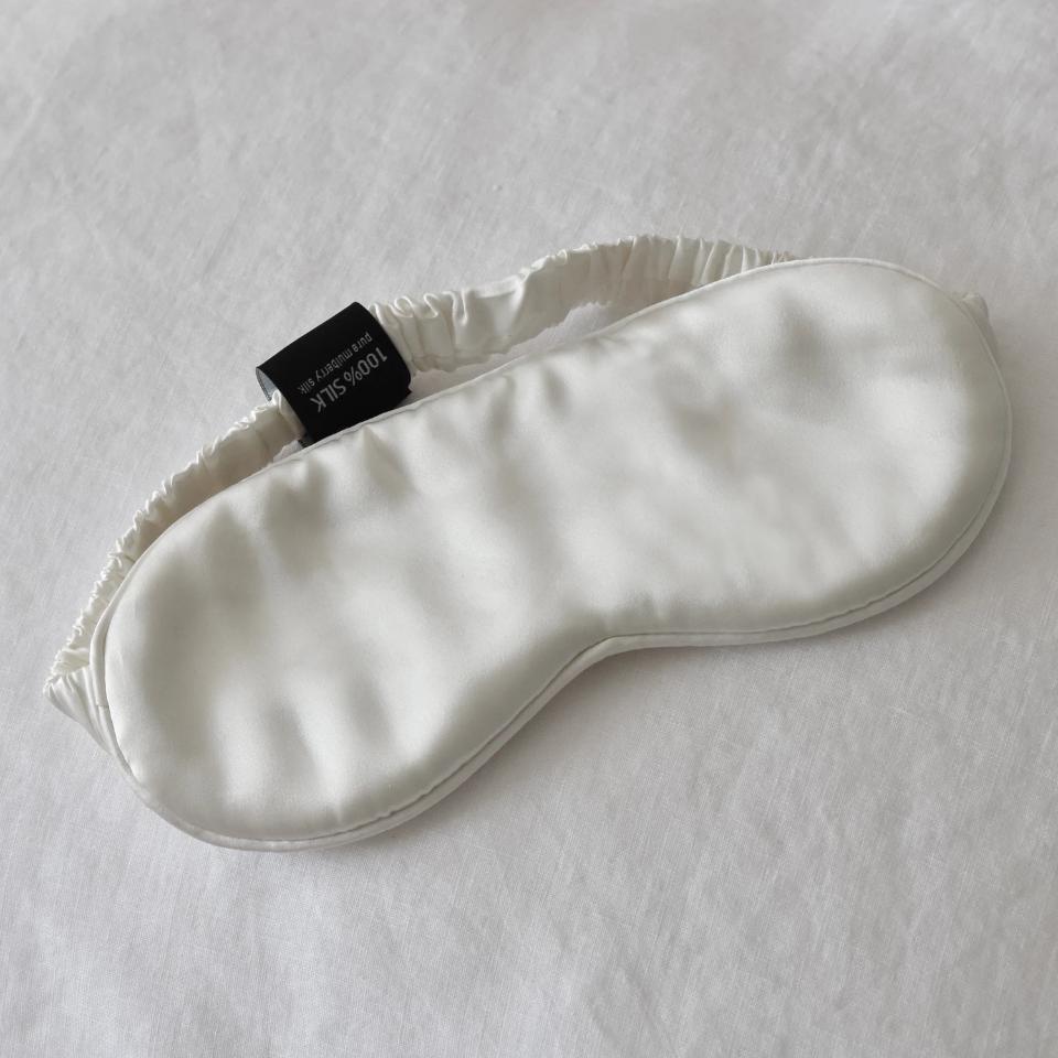 White Silk Eye Mask on White Linen Bedding