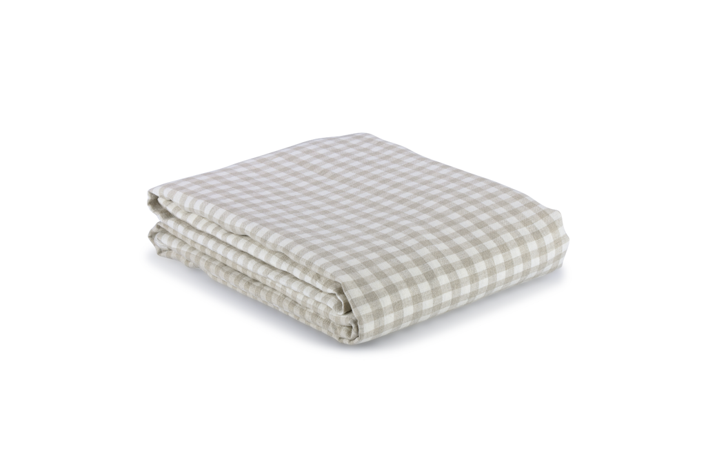 A Natural Gingham Linen Duvet Cover Folded on a white sheet