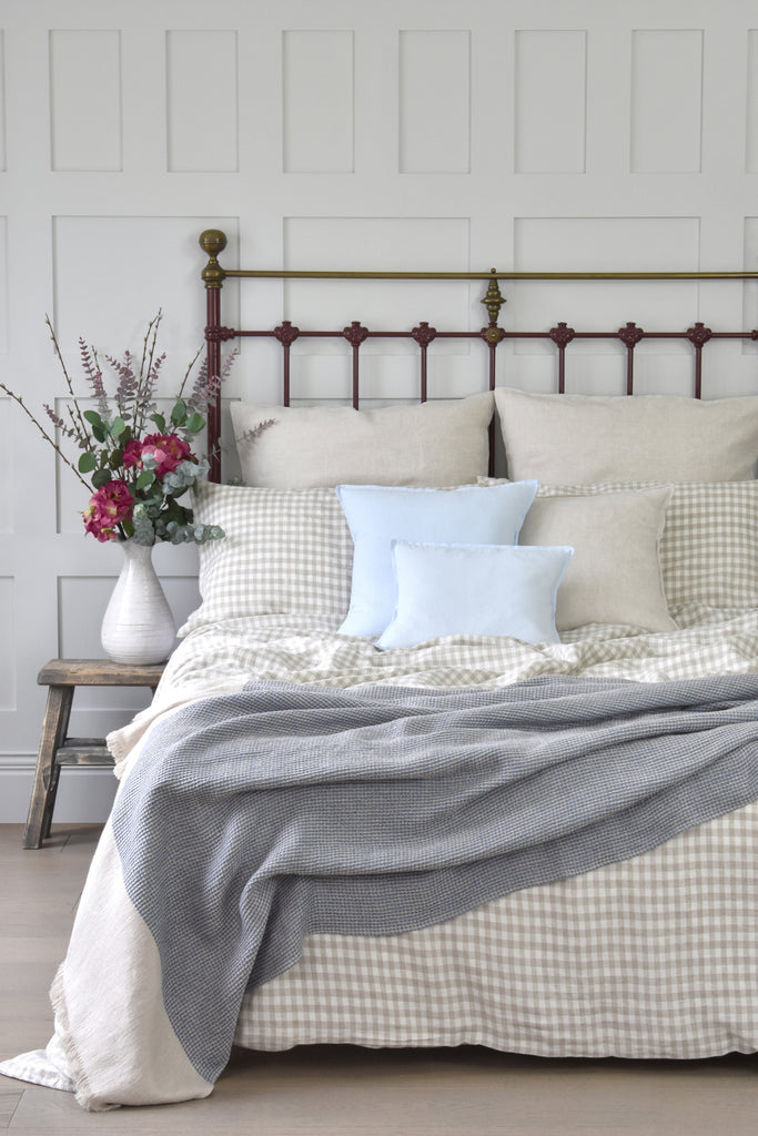 A Natural Gingham Checked Linen Duvet Cover on a Iron Bed with Linen Cushions and Linen Throw