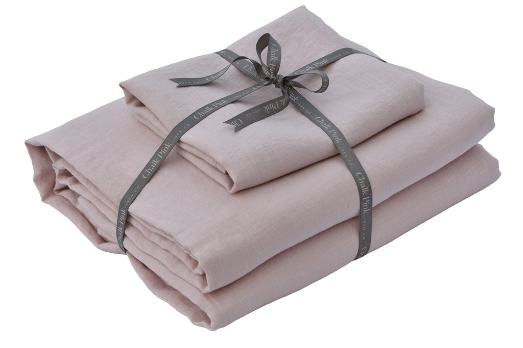 A Pink Bundle of Linen Bedding tied with a Ribbon