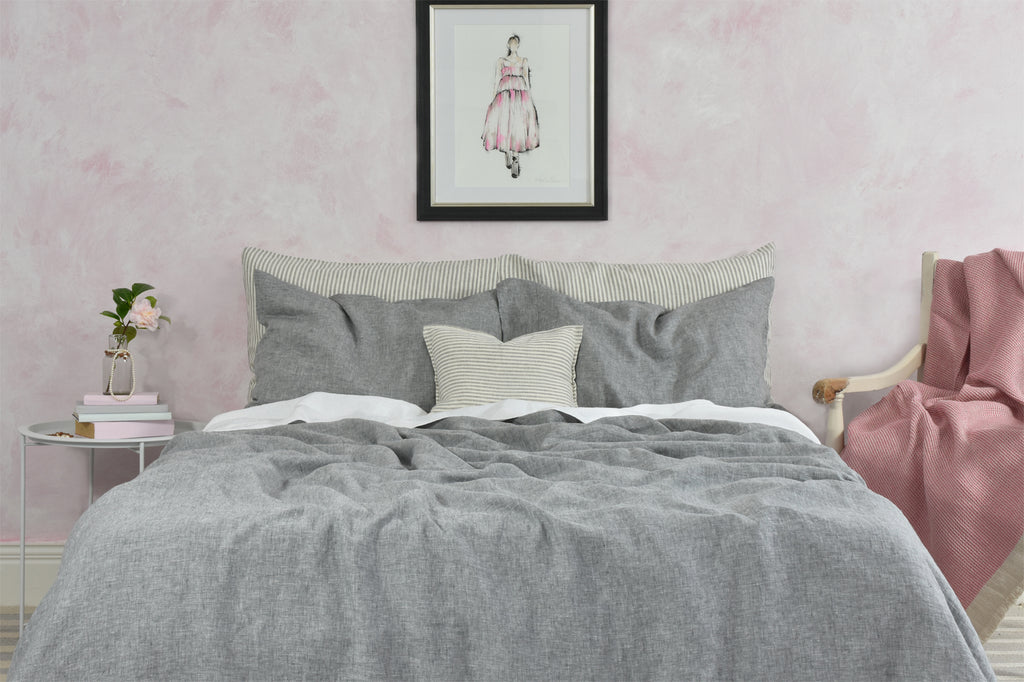 Light Grey Linen Duvet Cover in front of a Pink Painted Wall with a Chair with a Pink Linen Throw