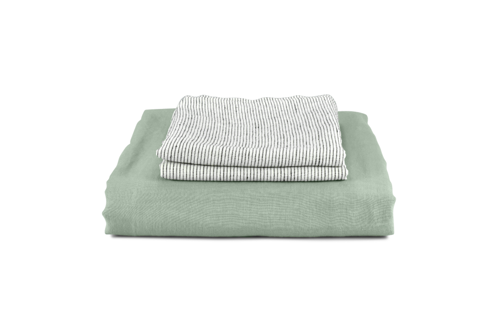 A Green Linen Bedding Set Folded with Pinstripe Linen Pillowcases on top