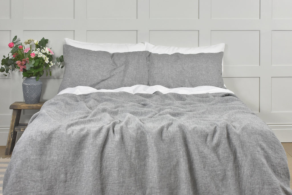 A Bed with A White Linen Sheet and Grey Linen Quilt Cover and Pillowcases