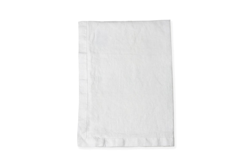 White Linen Table Runner Folded on a White Linen Sheet
