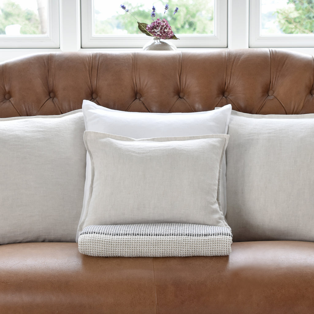 Small Linen Natural Flax Cushion On a Leather Sofa