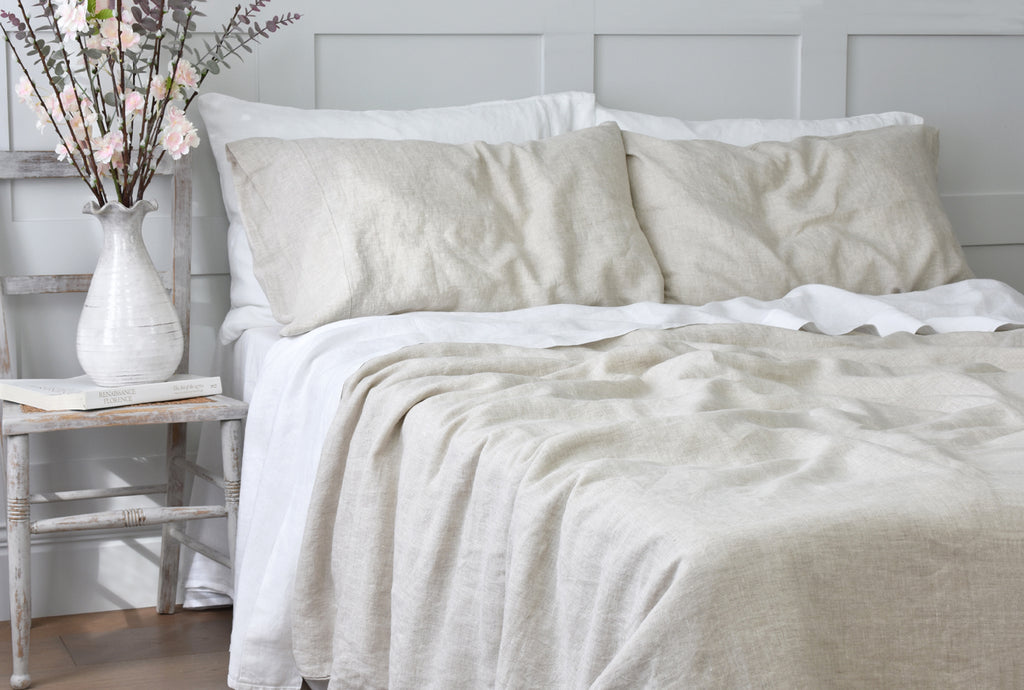 Natural Flax Linen Bedding on a Bed in a Bedroom with a Grey Pannelled Wall 