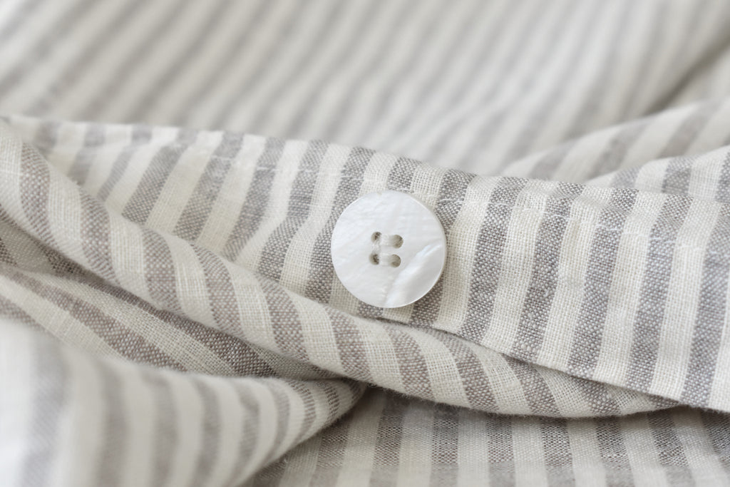 A Natural Ticking Duvet Cover with a Pearl Button Closure