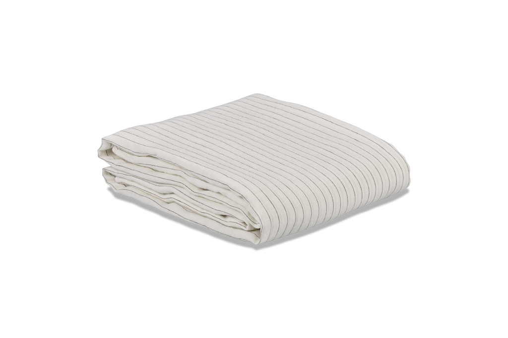 A Stripe Linen Duvet Cover Folded on a White Sheet