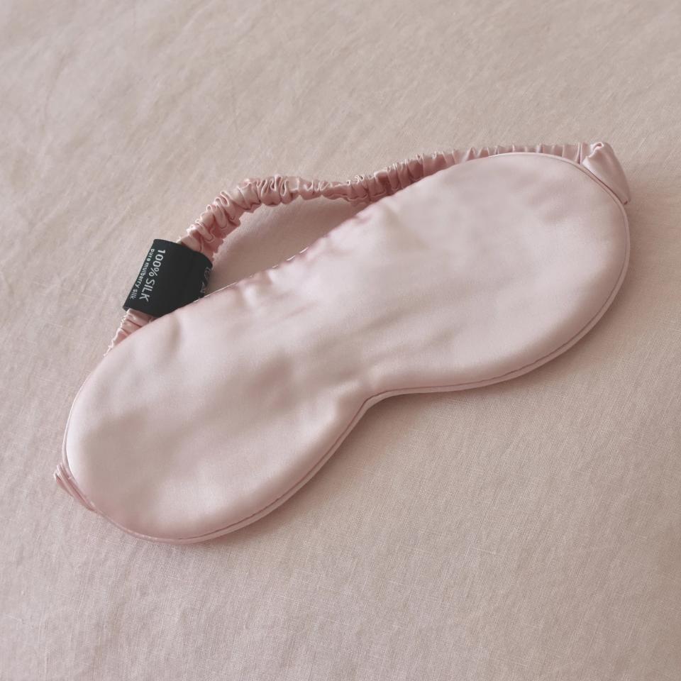 Pink Silk Sleep Mask on Pink Linen Bedding