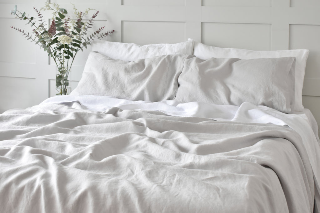 Grey Linen Duvet Cover on a bed with white linen pillowcases
