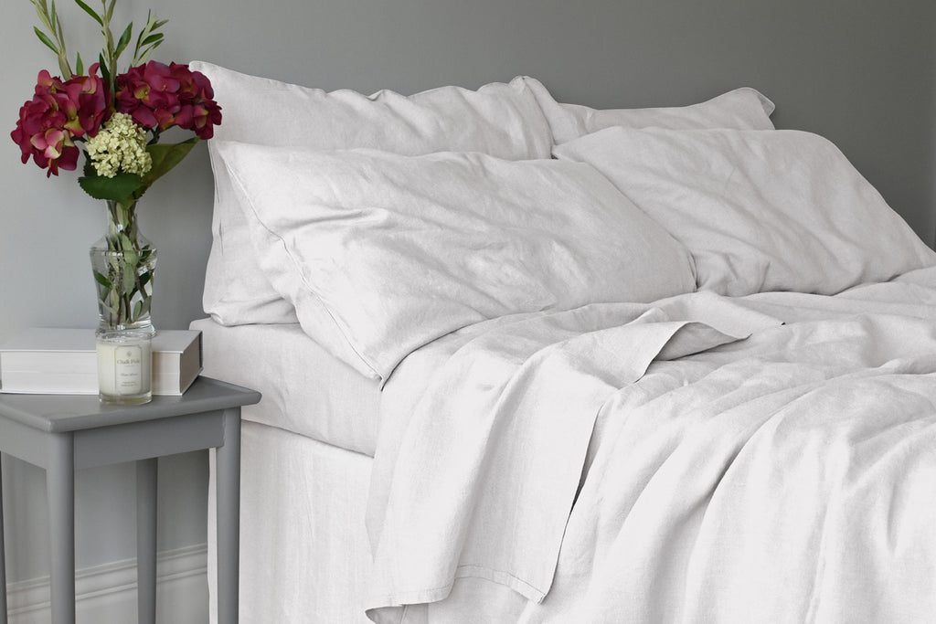 Light Grey Linen Duvet Set with Matching Linen Sheets in a Bedroom