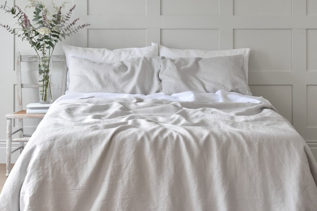Silver Grey Linen Bedding on a bed with white sheets