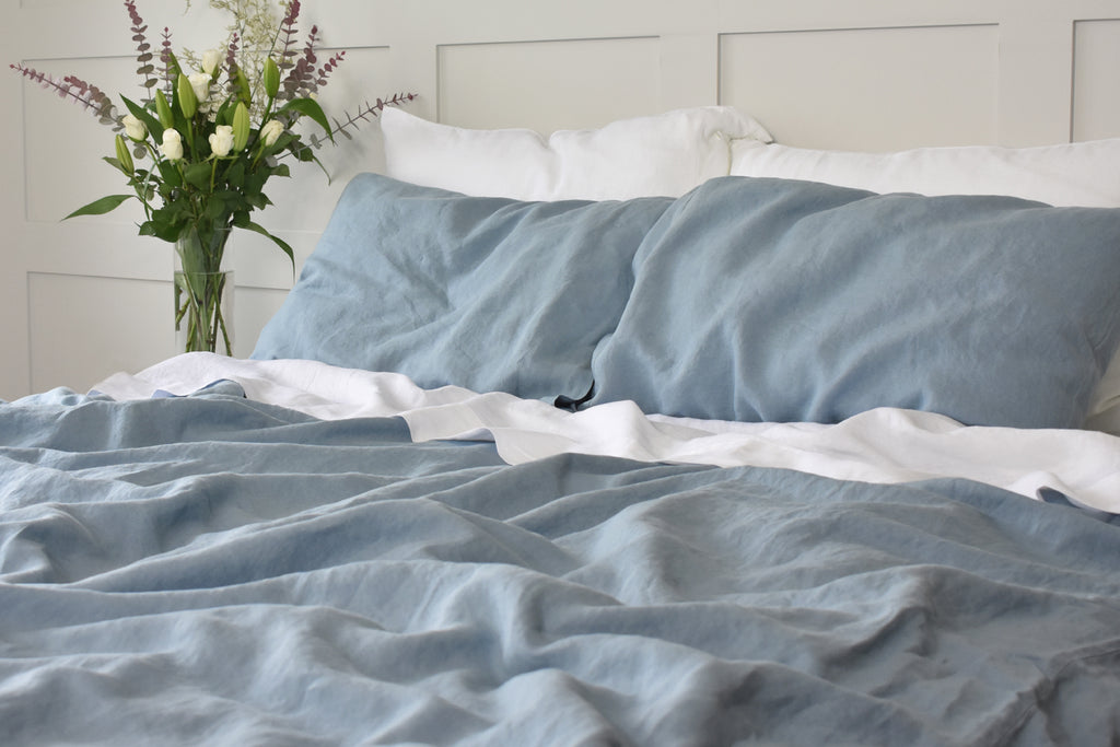 Stone Blue Bedding on a bed with White Linen Pillowcases