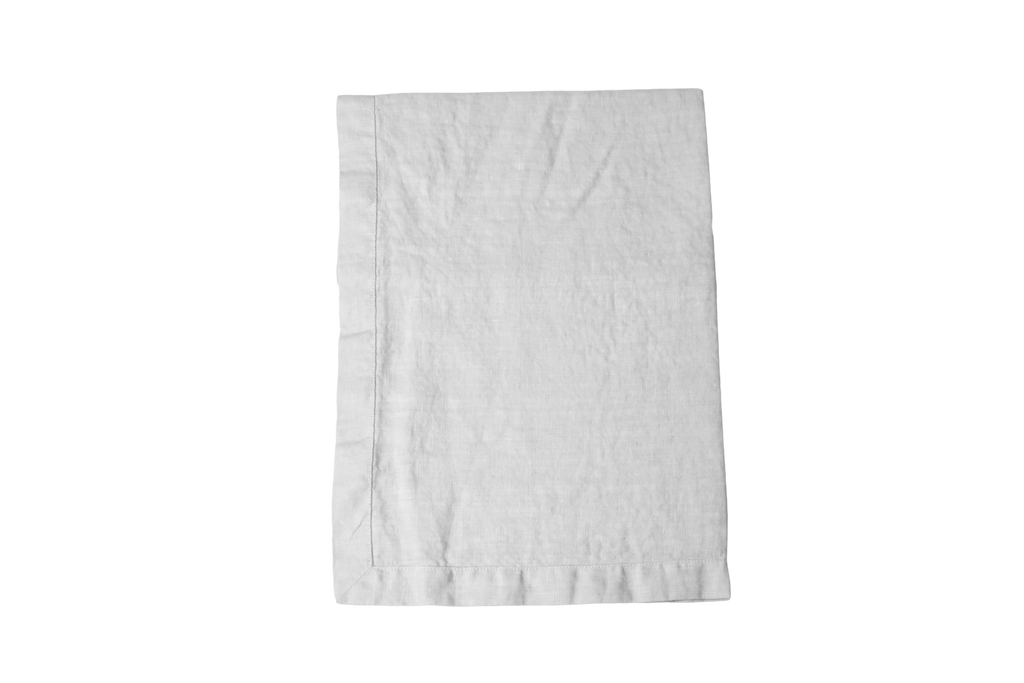 Light Silver Grey Linen Table Runner Folded on a White Linen Sheet