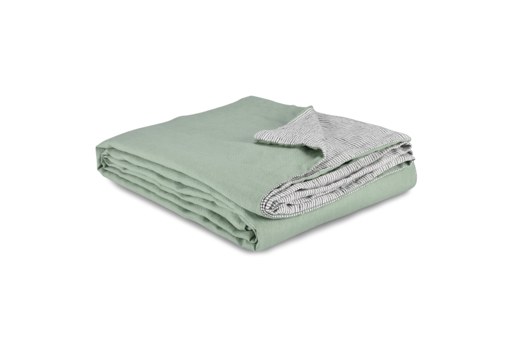 A Folded Green Linen Duvet Cover with a Corner Folded Back Showing Pinstripe Linen