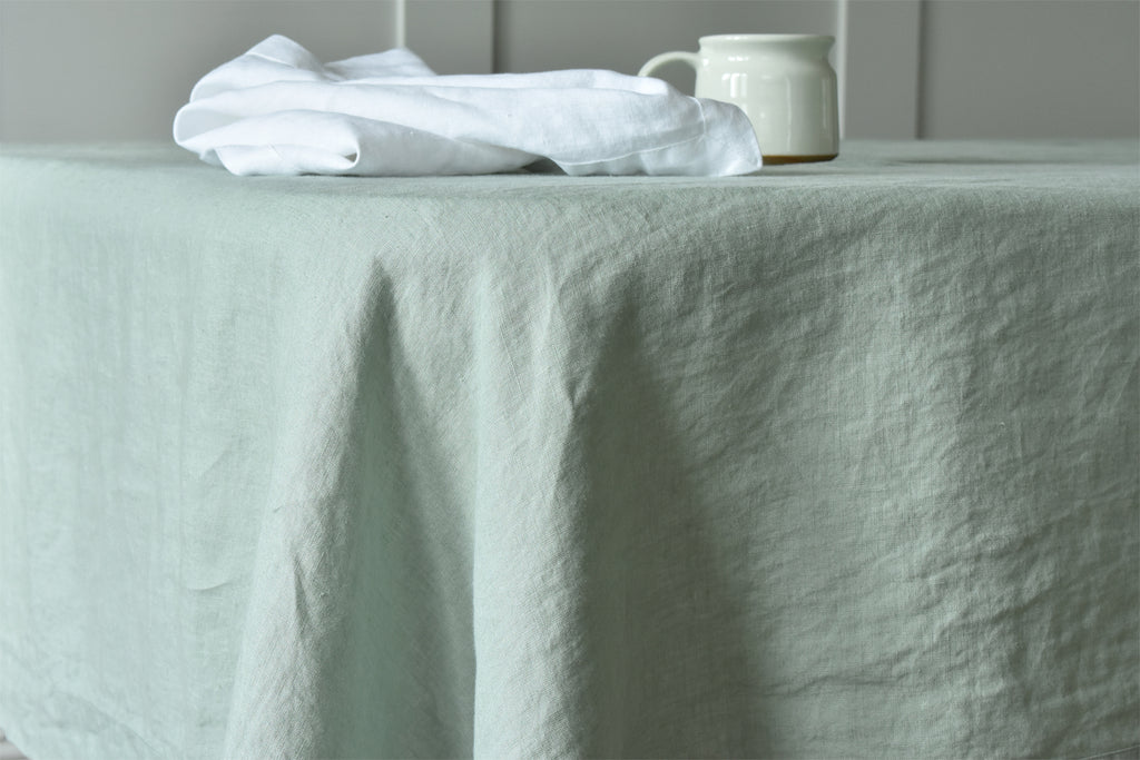 Prue Linen Green Tablecloth with a White Linen Napkin