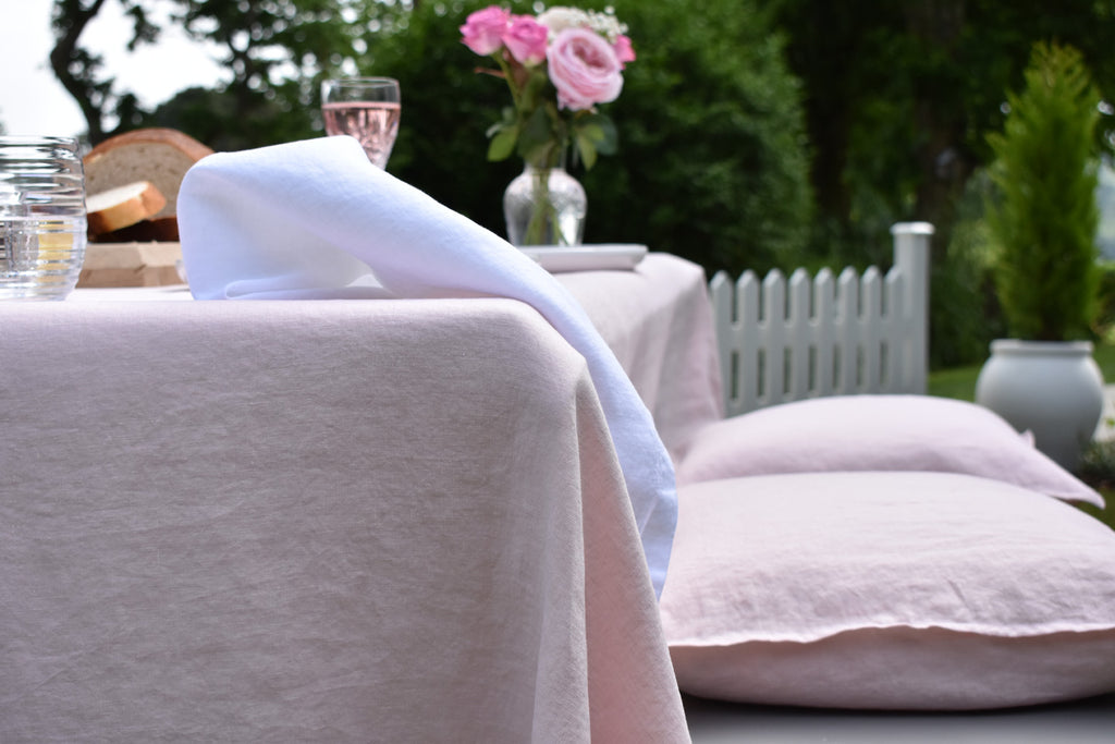 White Linen Napkin on a Pink Linen Tablecloth in the Garden