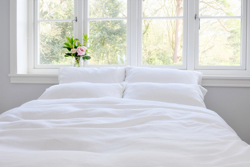 White Linen Duvet Cover UK on a Double Bed in Front of a window 